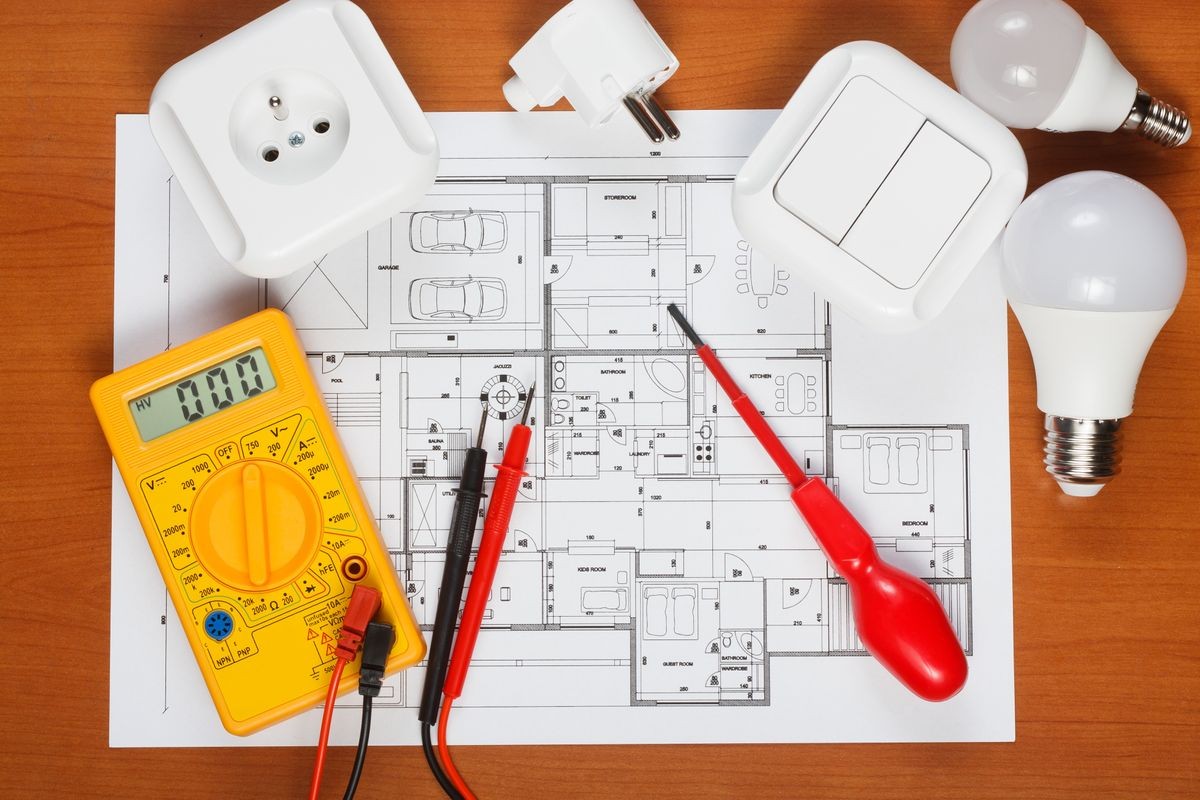 Electrical equipment, tools and house plans on the desk